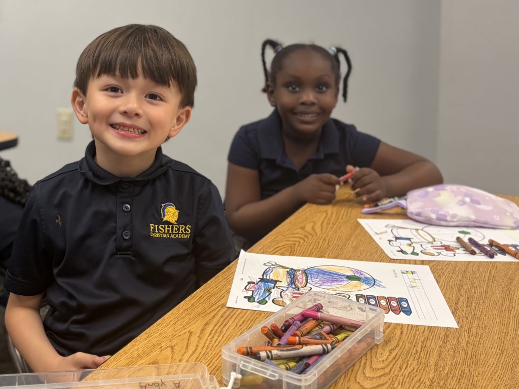 A teacher welcoming a new student at Fishers Christian Academy